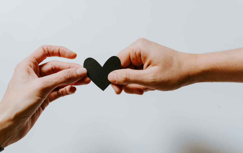 Hands forming a heart — love and solidarity in our community