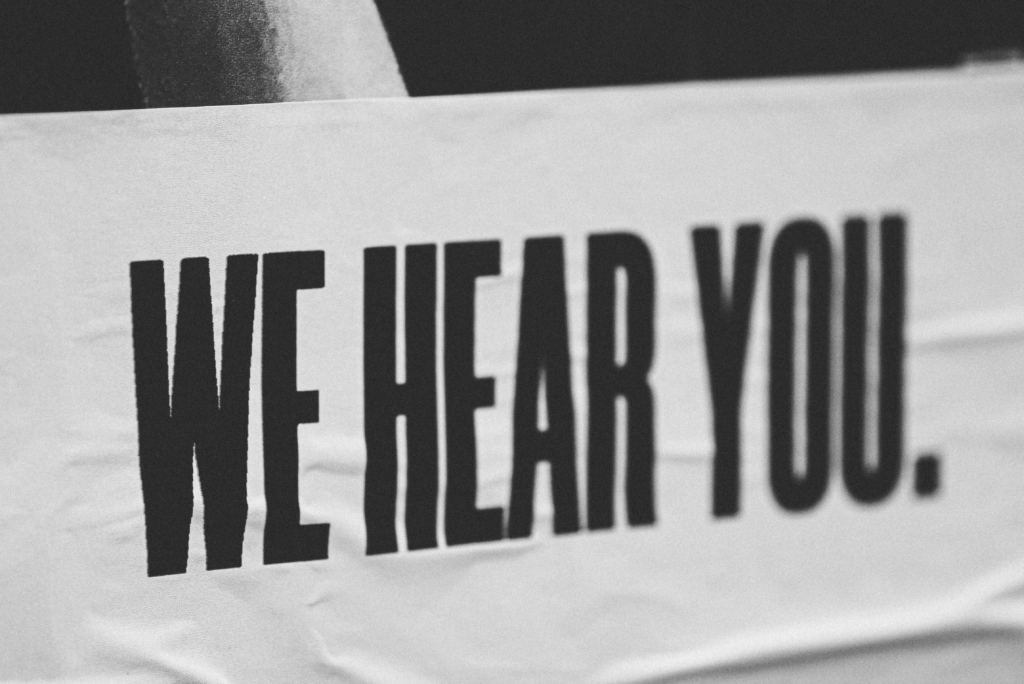 A sign reading ‘We hear you’